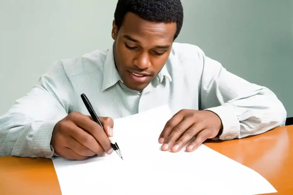 image_of_an_African_American_filling_out_a_cv - How to write a CV